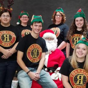 Rotaract Club students sit on Santa's lap