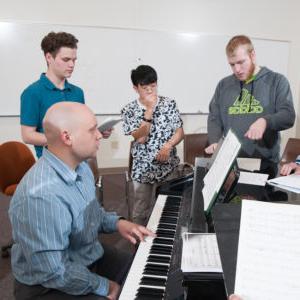 Students practice with instructor Steven Soebbing on the piano