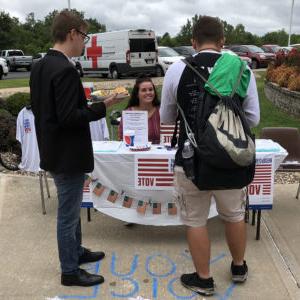 Students meet at the College Republicans booth at a Blazer BBQ